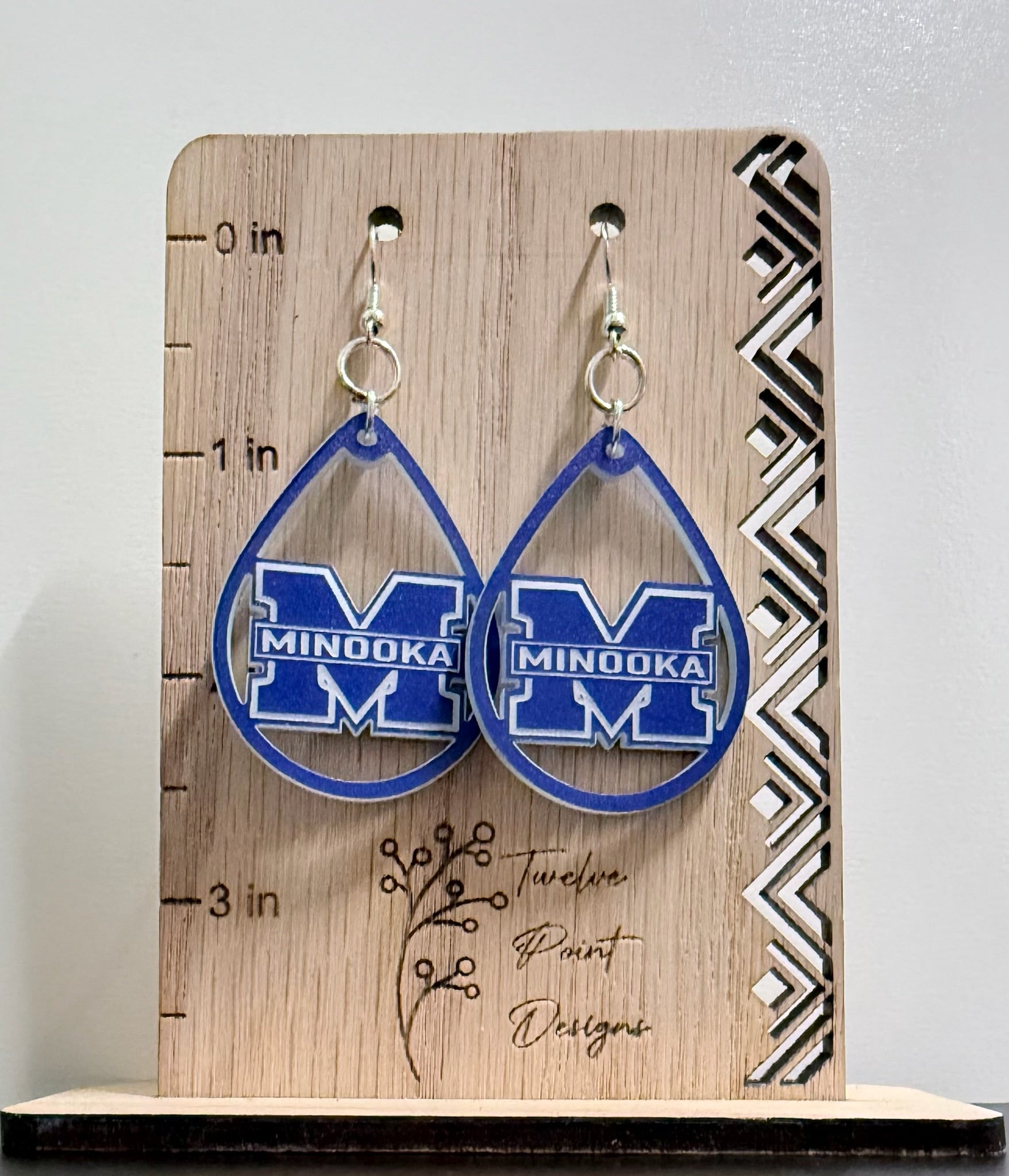 Earrings on board with ruler