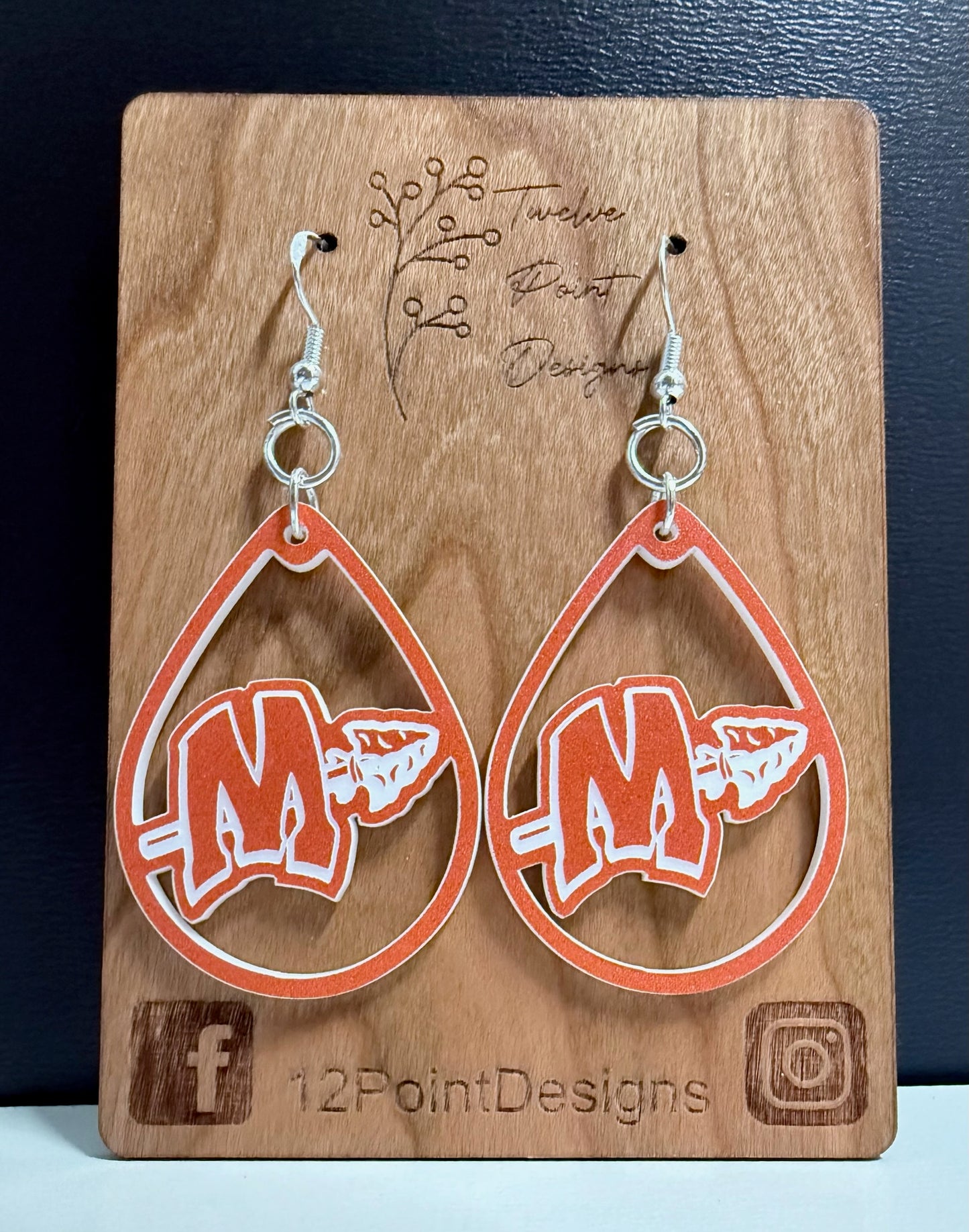 MCHS orange and white earring on card