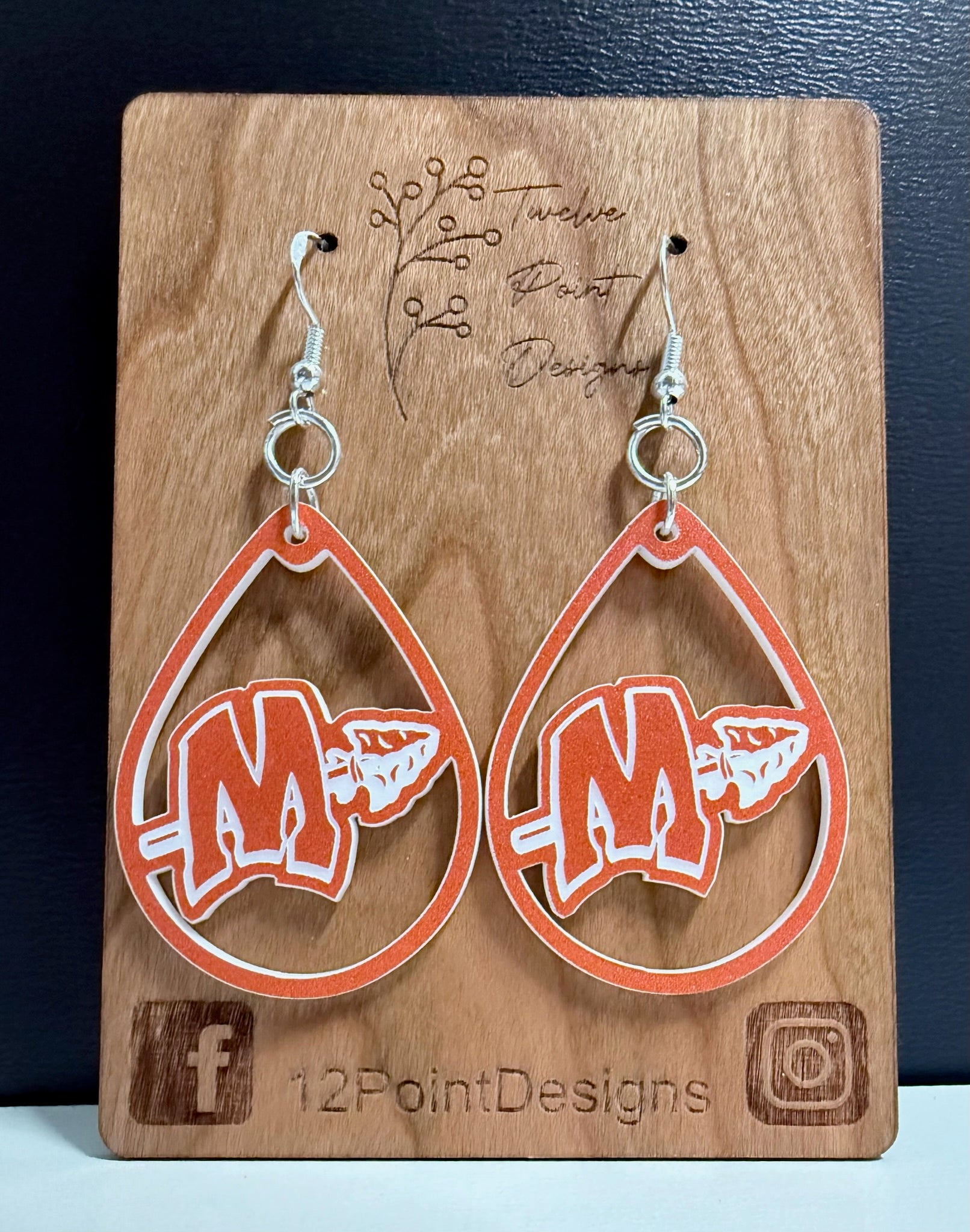 MCHS orange and white earring on card